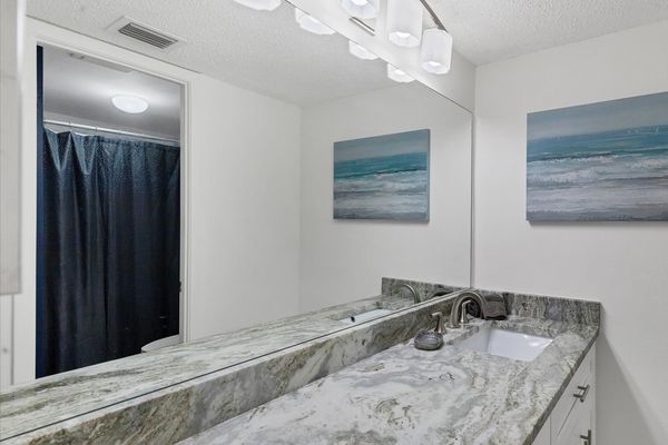 beautiful vanity in primary bathroom with shower/tub combo