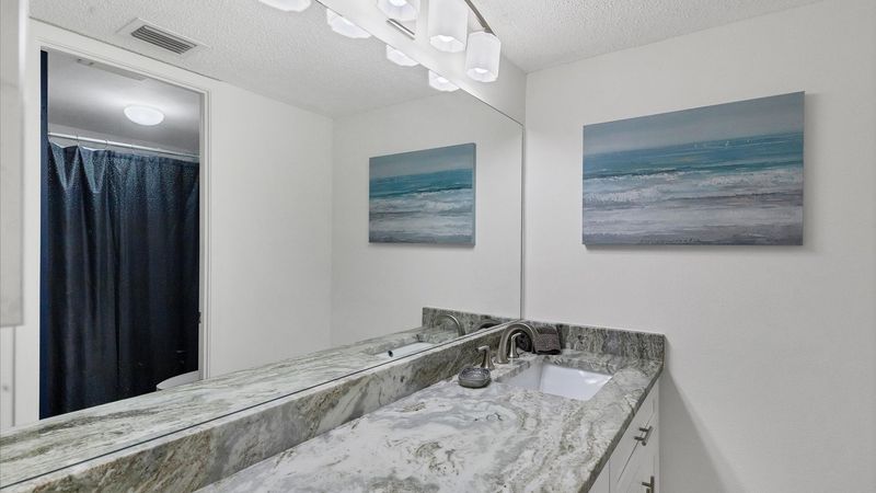 beautiful vanity in primary bathroom with shower/tub combo