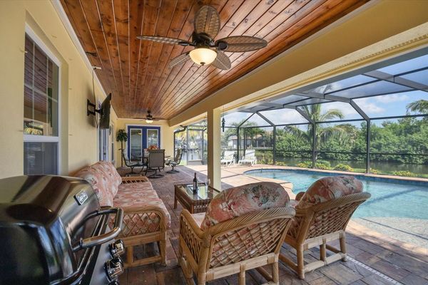 Spacious outdoor enclosed lanai overlooking the water and pool
