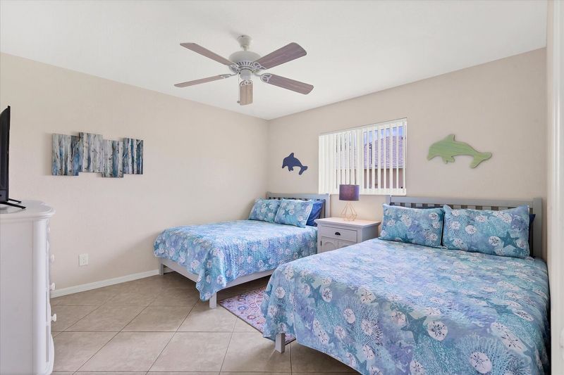 Guest bedroom 1 with two queen beds and 43-inch Smart TV