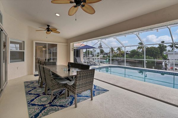 Outdoor dining area overlooking pool and canal