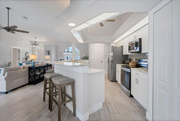 Kitchen overlooking living room. Kitchen island seat 6
