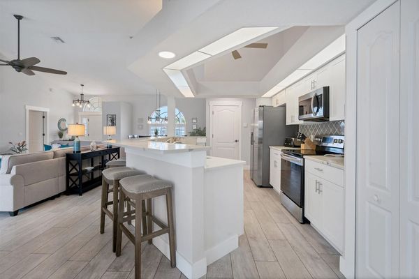 Kitchen overlooking living room. Kitchen island seat 6