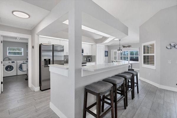 Fully-equipped kitchen leading to laundry room