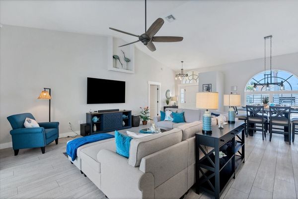 Living room with large, comfy sectional sofa and 75" Smart TV