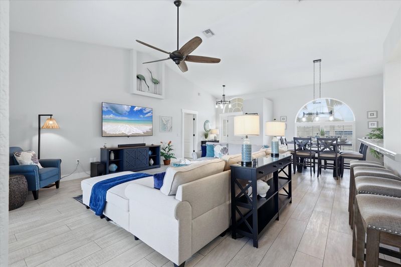 Bright, open living space. Living room features large, comfy sectional sofa and 75" Smart TV