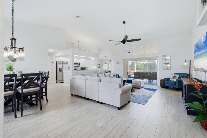 Bright, open living space. Living room features large, comfy sectional sofa and 75" Smart TV