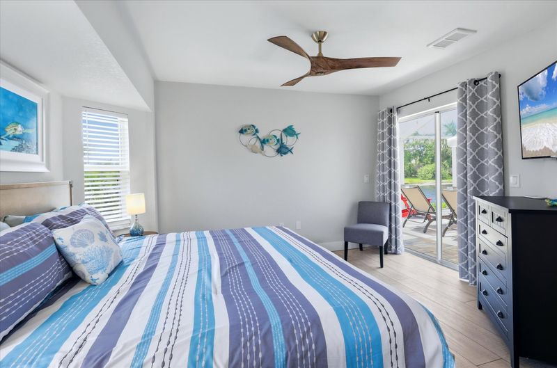 Bedroom #3 features a king bed, 48" Smart TV and lanai access