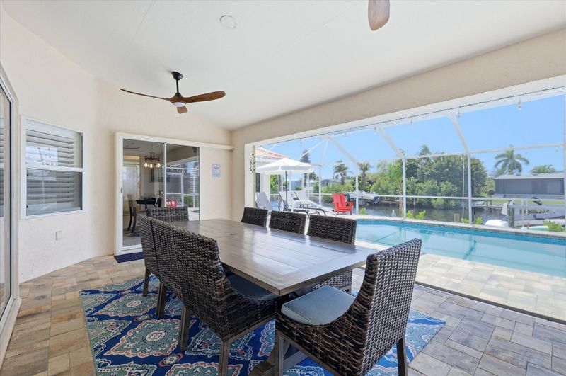 Outdoor living space overlooking the pool and canal beyond