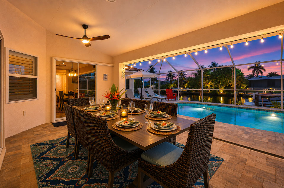 Outdoor living space overlooking the pool and canal beyond