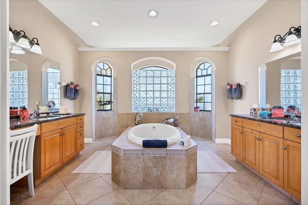 Primary bathroom with double vanities, walk-in shower and soaking tub