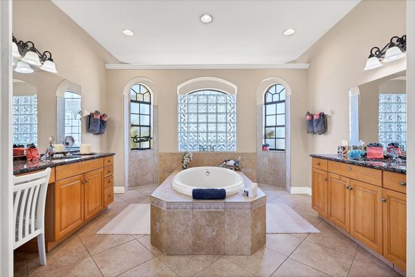 Primary bathroom with double vanities, walk-in shower and soaking tub