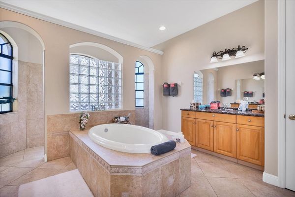 Primary bathroom with double vanities, walk-in shower and soaking tub