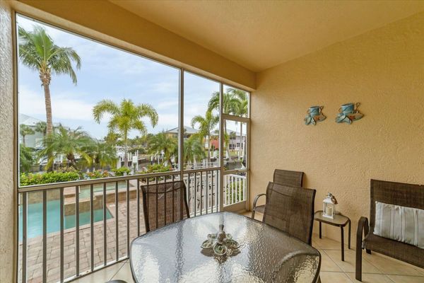 Outdoor dining area overlooking pool & canal