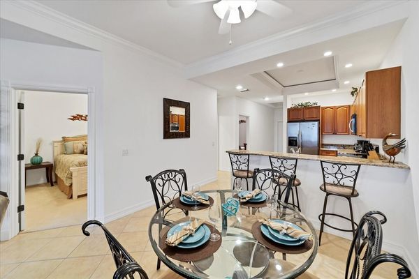 Dining table seats 4 while kitchen island seats another 3