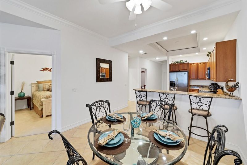 Dining table seats 4 while kitchen island seats another 3