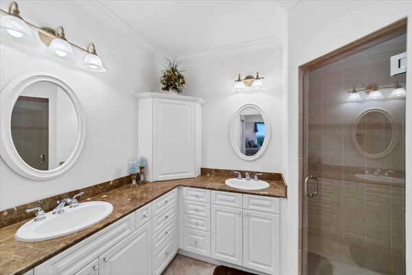 Primary bathroom with walk-in shower & double vanities
