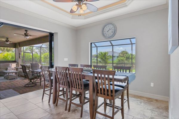 Dining area overlooking pool and canal. Dining table seats 8