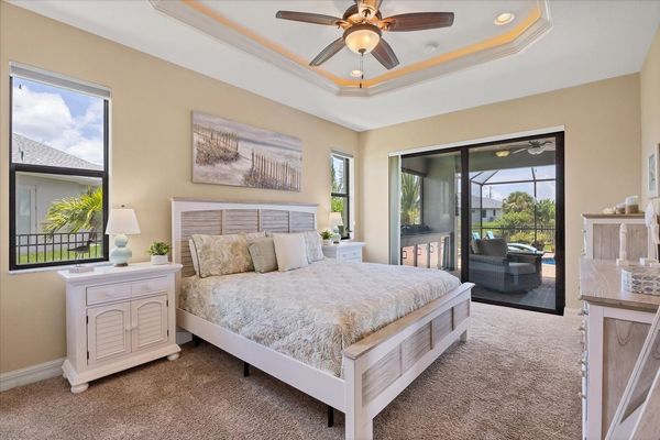 Primary bedroom with king bed, en suite, lanai access and 42" Smart TV