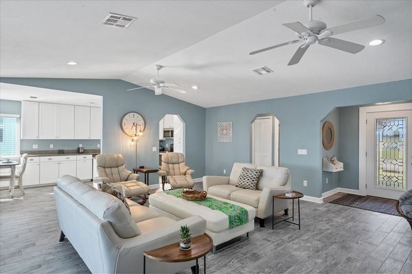 Bright, open living room with view of pool and canal