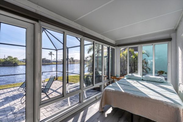 Sunroom nook with queen  bed has a room divider for privacy