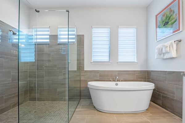 Indulge in luxury with our spacious bathroom featuring both a sleek walk-in shower and a relaxing bathtub.