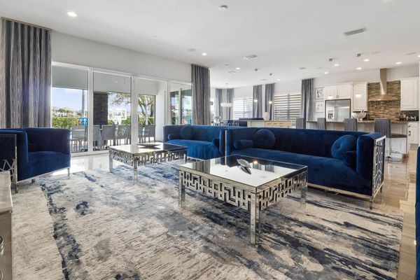 Sink into comfort in our spacious living room, where the serene blue hues of the couch effortlessly complement the plush carpet beneath your feet.