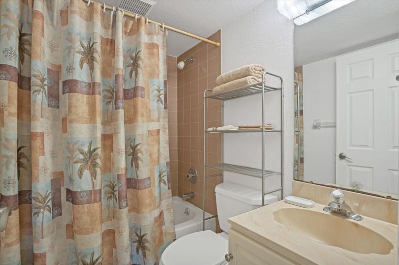 The guest bathroom has a shower/tub combo