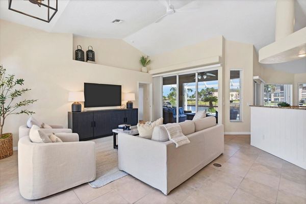 Bright, open living space with ample seating and 65-inch Smart TV