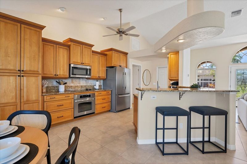 Fully-equipped kitchen over looking the living room and dining area