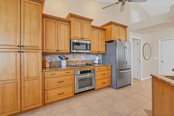 Fully-equipped kitchen over looking the living room and dining area