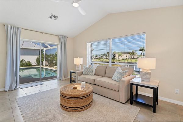 Guest bedroom 2 overlooks the canal & features a wet bar, lanai access and a queen sleeper sofa