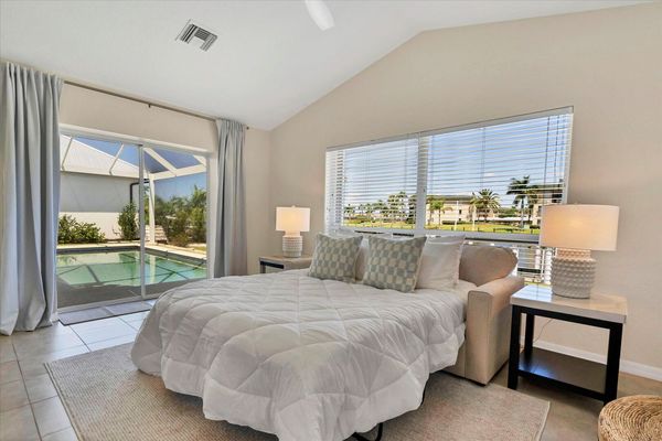 Guest bedroom 2 overlooks the canal & features a wet bar, lanai access and a queen sleeper sofa