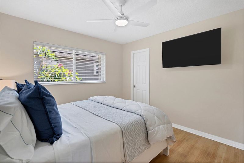 Guest bedroom with queen bed and 50-inch Smart TV