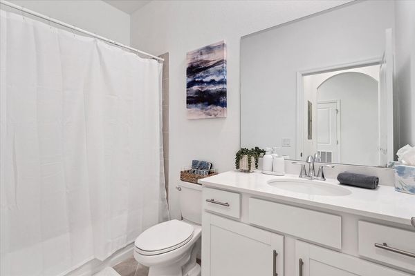 The guest bathroom has a shower/tub combo
