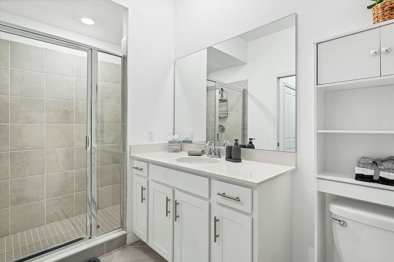 The ensuite bathroom has a walk-in shower