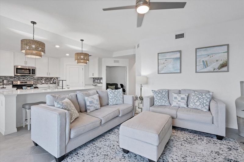 Beautiful living room featuring ample seating and 65-inch Smart TV with HD antenna