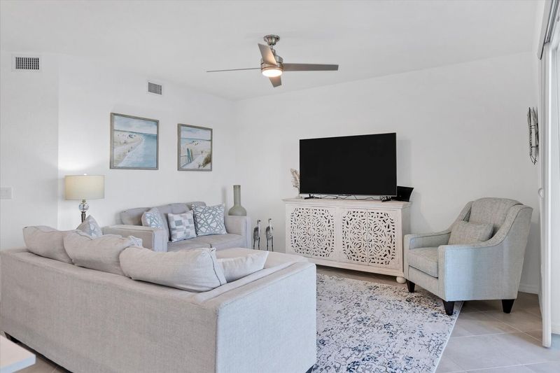 Beautiful living room featuring ample seating and 65-inch Smart TV with HD antenna