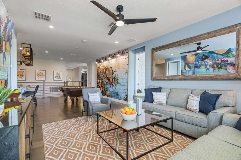 Gather in the 2nd floor loft area, a versatile space perfect for lounging, watching movies, or enjoying casual conversations