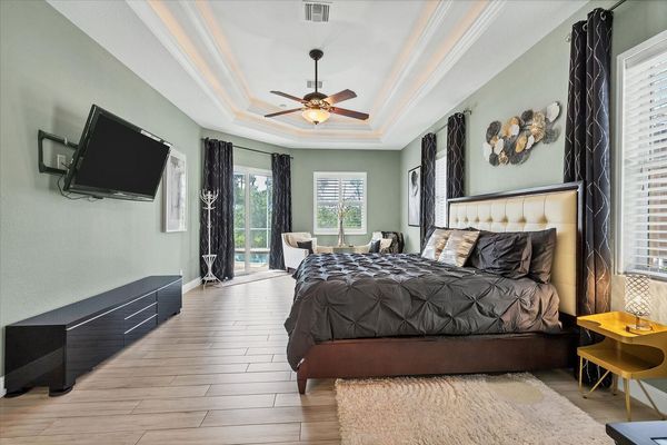 Large primary bedroom with king bed, en suite, lanai access, and  55-inch Roku TV