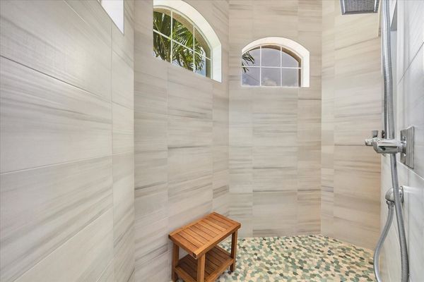 Beautiful primary en suite with large walk-in shower and double vanities