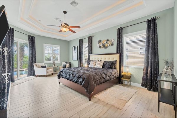 Large primary bedroom with king bed, en suite, lanai access, and  55-inch Roku TV