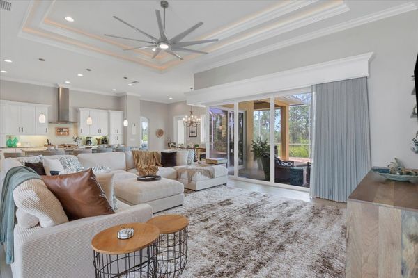 Gorgeous, open living space overlooking private pool, canal, and nature preserve beyond. Living room features lots of comfy seating and 70-inch Smart TV