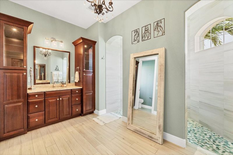 Beautiful primary en suite with large walk-in shower and double vanities