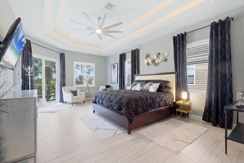 Large primary bedroom with king bed, en suite, lanai access, and  55-inch Roku TV
