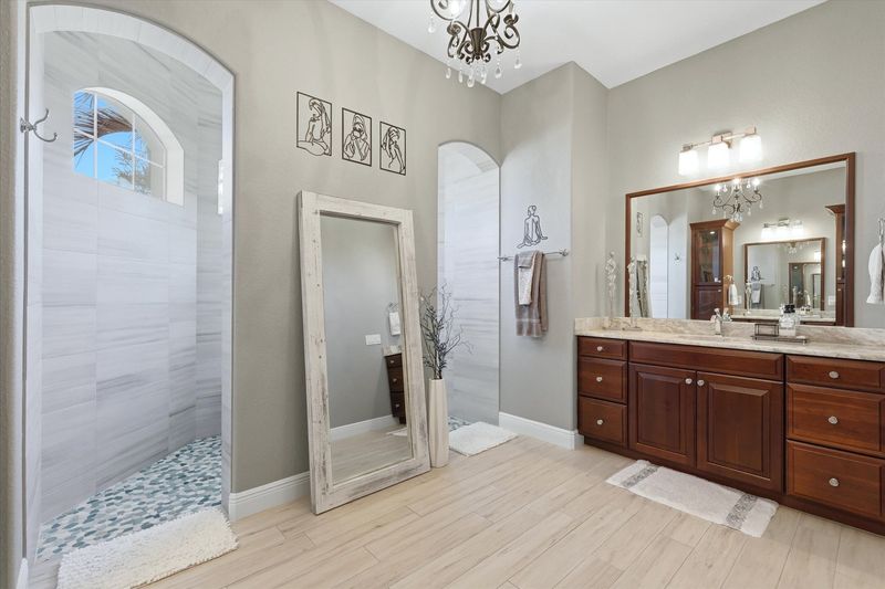 Beautiful primary en suite with large walk-in shower and double vanities