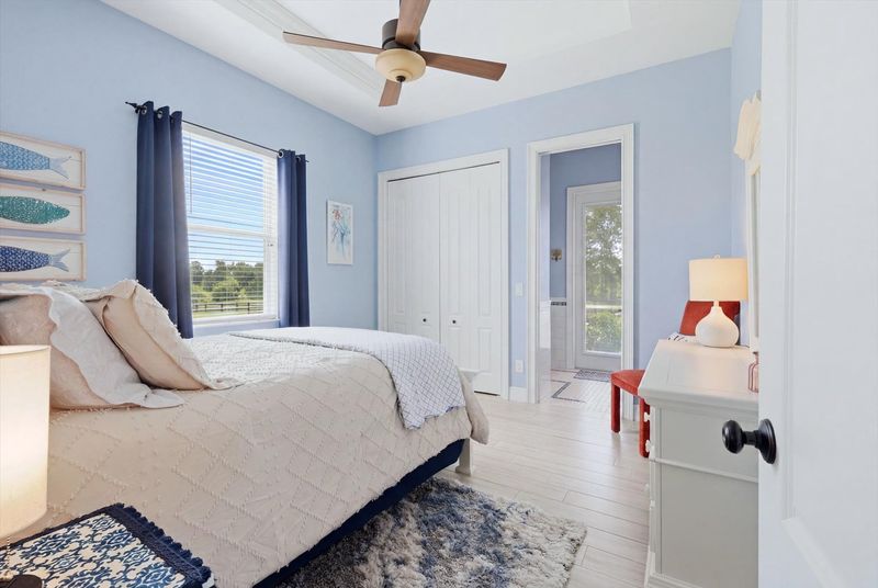 Guest bedroom 1 features one queen bed, attached bathroom with lanai access