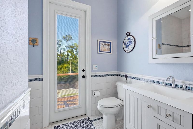 Attached bathroom with walk-in shower and lanai access