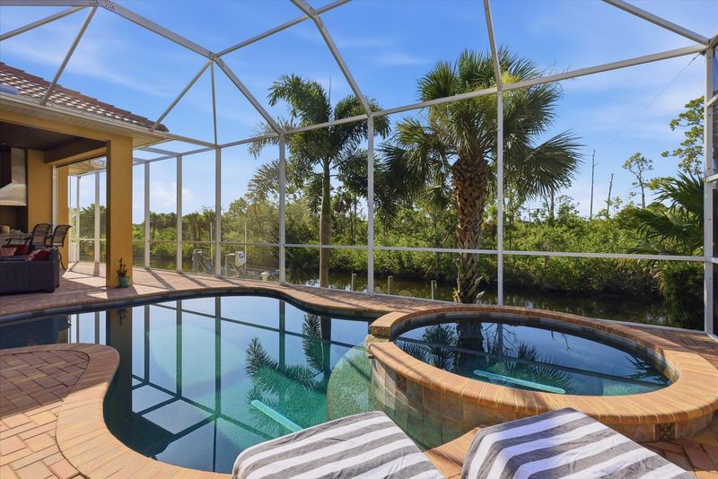Sparkling private saltwater pool & spa overlooking water. Lanai features remote controlled privacy screens. Pool size is 17'L x 10'W x 6'D