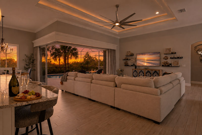 Gorgeous, open living space overlooking private pool, canal, and nature preserve beyond. Living room features lots of comfy seating and 70-inch Smart TV